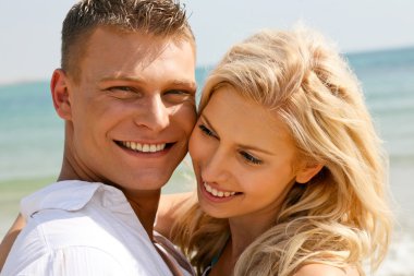 Couple enjoying life at beach clipart