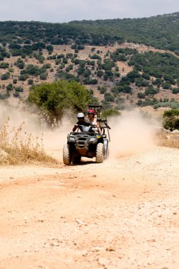 Quadbike action on a dirt track clipart