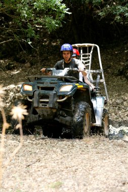 Couple riding ATV off road clipart