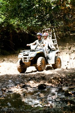 Couple riding through dirt clipart