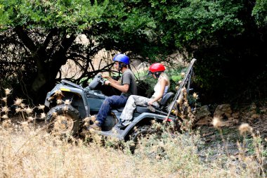 ATV climbing, couples enjoying ride clipart