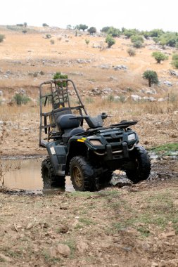 Military four wheeler in the desert clipart