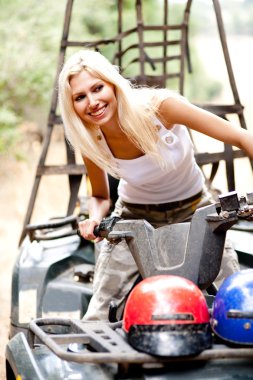 Blonde woman riding quad in style clipart