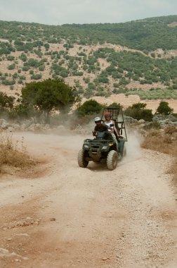 Quad couple on dirt road clipart