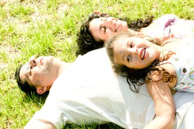 Couple lying down with daughter clipart