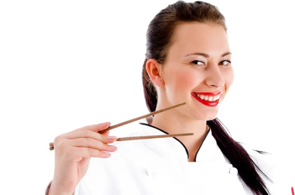 Female chef holding chopsticks — Stok fotoğraf