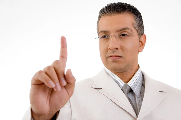 Smiling businessman looking his finger — Stock Photo, Image