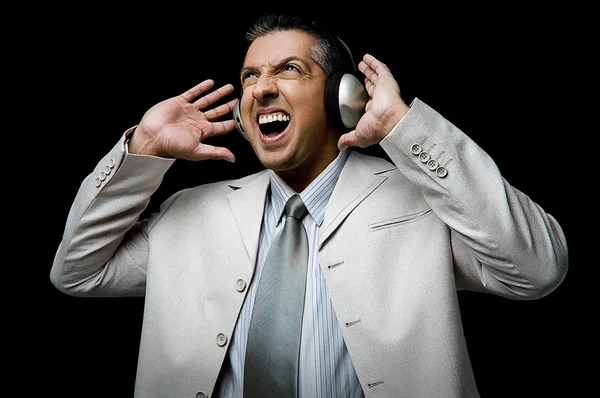 Businessman listening music — Stock Photo, Image