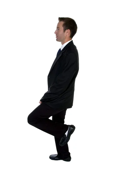 Jovem empresário benting uma perna — Fotografia de Stock