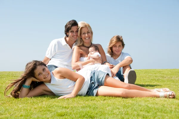 Família sorridente relaxante no dia ensolarado — Fotografia de Stock