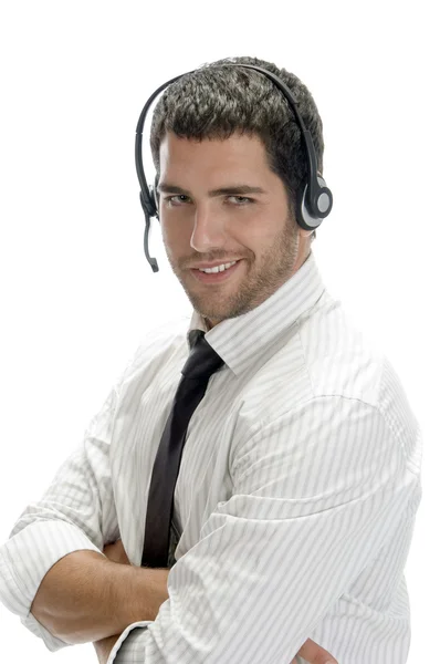 Uomo d'affari sorridente in posa con auricolare — Foto Stock