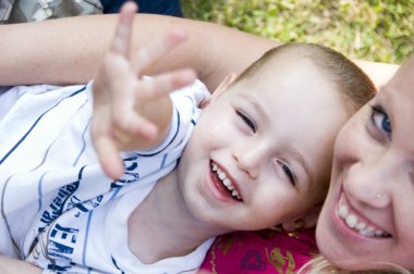 Happy mother and child playing clipart