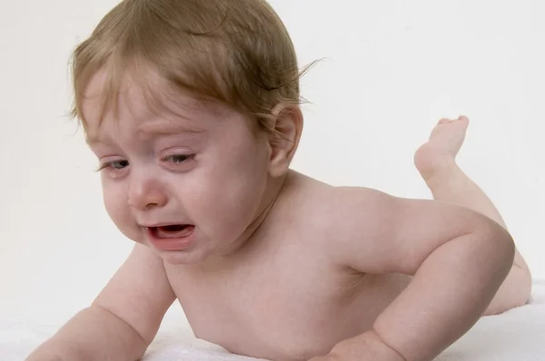 Płacz małe dziecko, leżąc na podłodze — Zdjęcie stockowe