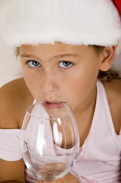 Küçük kız santa şapka ve şarap cam — Stok fotoğraf