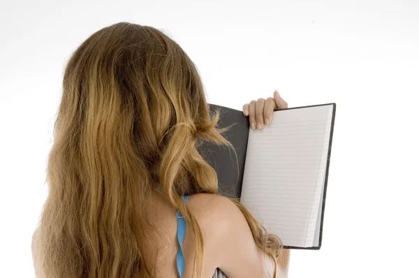 Back pose of girl reading note book — Stock Photo, Image