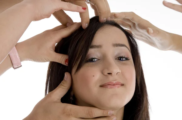Pretty teenager surrounded by many hands — Stock Photo, Image