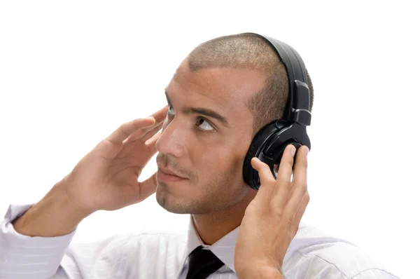 Man holding earphone and looking upwards Stock Photo