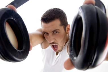 Close up of young man holding headphones clipart