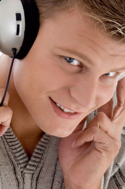 Young man with headphones enjoying music clipart