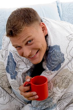 Man enjoying coffee in bed clipart
