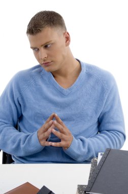 Young male sitting idle in office clipart