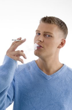 Handsome young guy smoking in style clipart