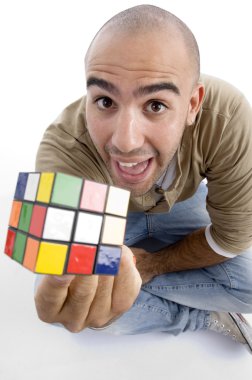 Young guy showing puzzle cube to camera clipart