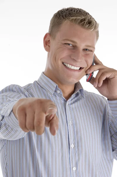 Pointing businessman talking on mobile — Stockfoto