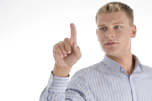 Handsome guy looking at his index finger — Stock Photo, Image