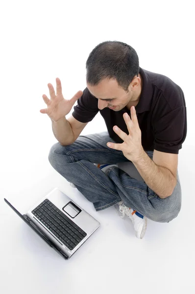 Angry young man with his laptop — Stock Photo, Image