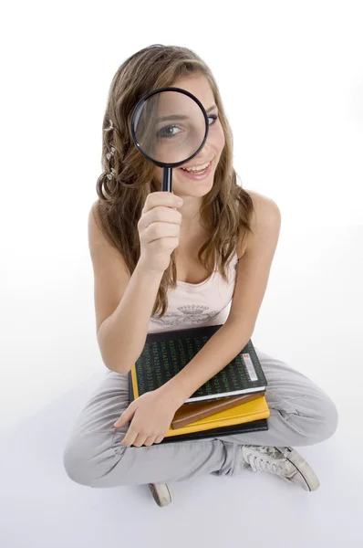 Happy girl with books and lens — Stock Photo, Image