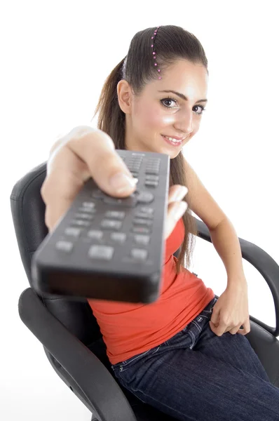 Beautiful young girl showing remote — Stock Photo, Image