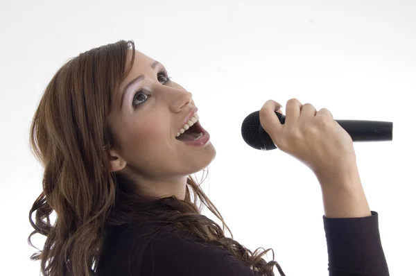 Woman singing in microphone — Stock Photo, Image