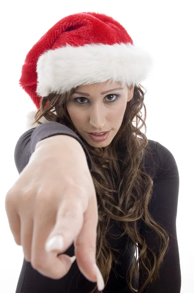 Woman wearing christmas hat pointing — Stock Photo, Image