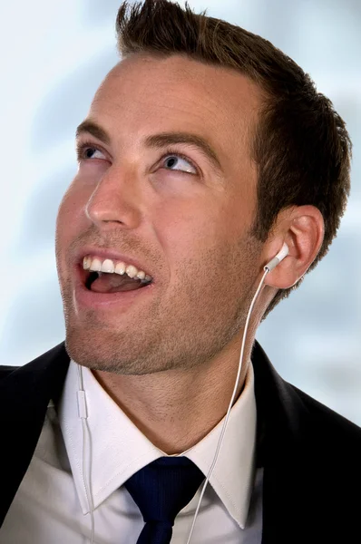 Portrait of businessman listening music — Stock Photo, Image