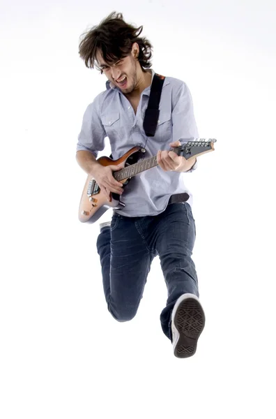 Young guitarist jumping in joy — Stock Photo, Image