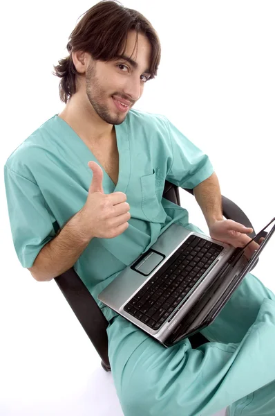 Doctor working on laptop wishing luck — Zdjęcie stockowe