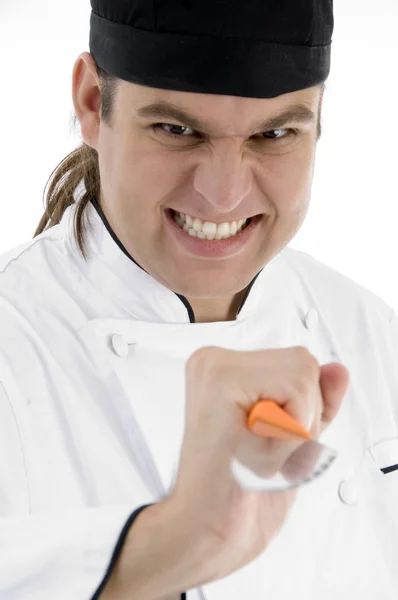 Angered male chef showing kitchen tool — Stock Photo, Image