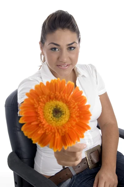 Lovely girl showing orange flower — Stock Photo, Image