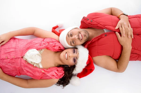 Young lovers in christmas hat lying — Stock Photo, Image