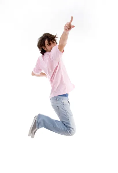Handsome guy jumping high and pointing — Stock Photo, Image