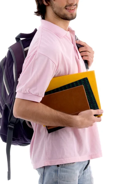 Młody człowiek trzyma worek i książek — Zdjęcie stockowe