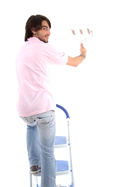 Geri bir adam boya silindiri ile poz — Stok fotoğraf