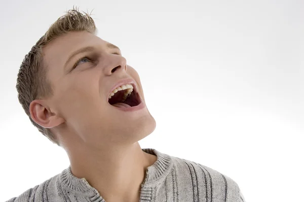 Laughing young man looking upwards — Stock Photo, Image
