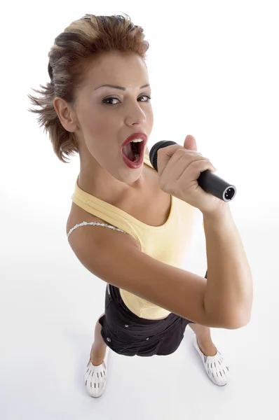 Sexy woman singing in microphone — Stock Photo, Image