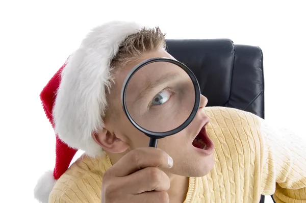 Young man looking through magnifier — Stock Photo, Image