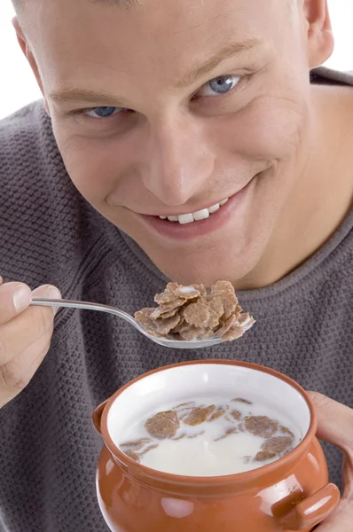 Young guy enjoying cornflakes and milk — Stock Photo, Image