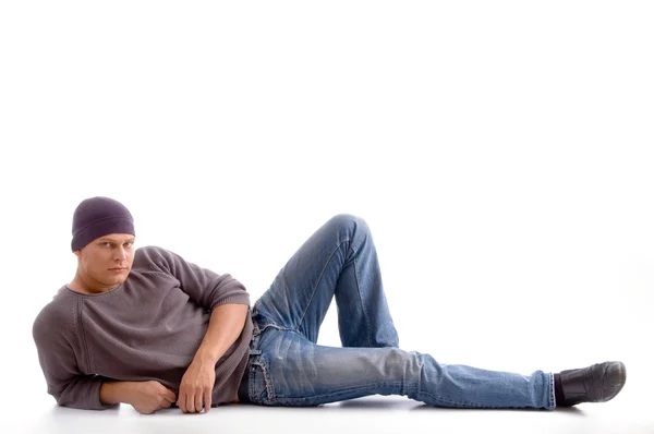 Handsome young guy posing on floor — Stock Photo, Image