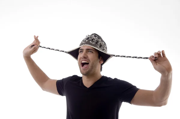Young man playing with his cap — Stock Photo, Image