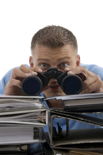 Young man looking through binoculars — Stock Photo, Image